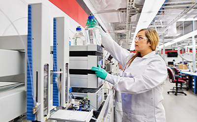 Practical aspects on HPLC Method development and LC-Troubleshooting The cover image for the webinar on 'Practical Aspects of HPLC Method Development and LC-Troubleshooting,' featuring a female lab chemist in a laboratory setting. Adorned in green gloves, lab goggles, and a white lab coat, she is actively engaged in an instrument operation.