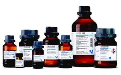 A collection of seven brown glass indicator bottles with white labels, varying in size, arranged in a row against a white background.