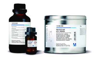 Two containers of chemical substances, one a small brown bottle and the other a larger metal can, both labeled with scientific information.
