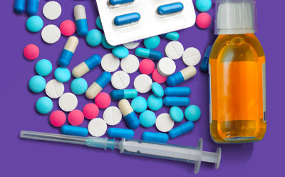 A colorful assortment of medications displayed on a purple background, including various pills in blue, pink, and white, a blister pack of capsules, a bottle of liquid medicine, and a syringe.