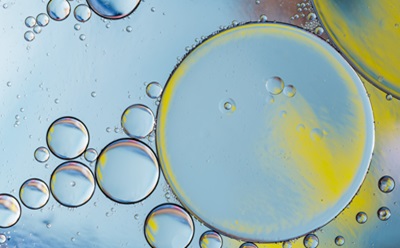 Detergents and Surfactants Close-up image of colorful circular shapes and bubbles with a vibrant combination of red, yellow, and green hues.