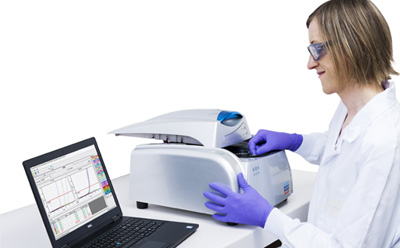 Lab worker operating an Assurance® GDS Rotor-Gene Q Thermocycler