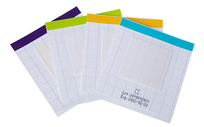 A set of four rapid-testing strips with color-coded headers, each representing a different test for quickly identifying indicator organisms, complete with batch number and expiration date for quality assurance.