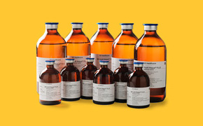 Cell Separation Media A collection of amber glass bottles of various sizes, labeled with white and blue text, against a yellow background.