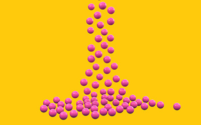 Small beads falling on yellow background