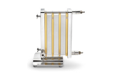Single-pass TFF system with Pellicon capsules and cassettes, shown with a metal frame and vertical gold-colored membranes.