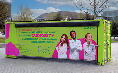Curiosity Cube Curiosity Cube, a brightly colored shipping container used for science experiments.