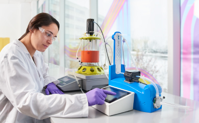 Female process development engineer performing cell culture scale-up studies.