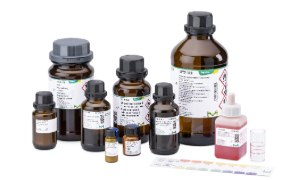 A variety of chemical bottles in different sizes, including brown glass and plastic containers, all labelled with safety information and branding from Supelco, accompanied by a color chart for reference.