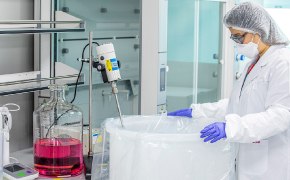 A photo showing a scientist and custom cell culture media