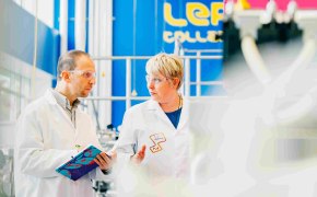 A photo showing two process scientists discussing and taking notes on a notebook in a M Lab™ Collaboration Center.