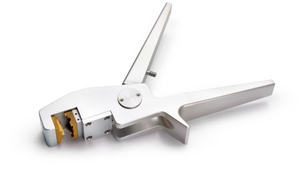 Metal tool on white background with a space at one end where tubing should be placed. Tool designed for manual use with gloved hands. Metal tool on white background with a space at one end where tubing should be placed. Tool designed for manual use with gloved hands.