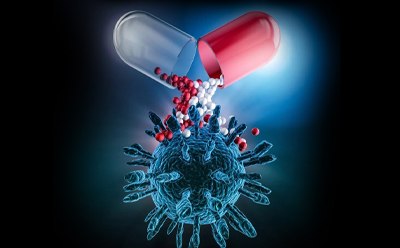 Illustration of a capsule releasing small drug particles toward a biological target structure.
