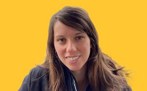 Jessica Freire Feitor headshot on a vibrant yellow background