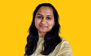 Sakshi Kabra Malpani headshot on a vibrant yellow background