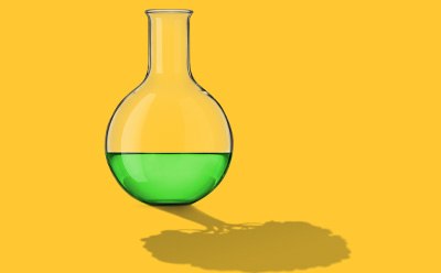 A flask with green liquid on yellow background, reflection has the shape of a tree