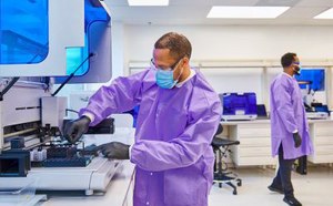 Scientists performing biosafety testing and manufacturing in a laboratory setting.