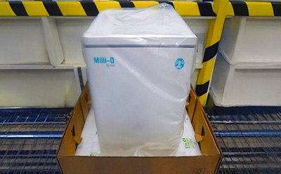 Milli-Q® system in box with bio-based foam packaging, showcasing switch from petroleum to bio-based materials.