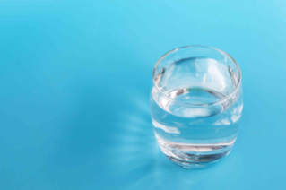 Glass of drinking water on a blue background