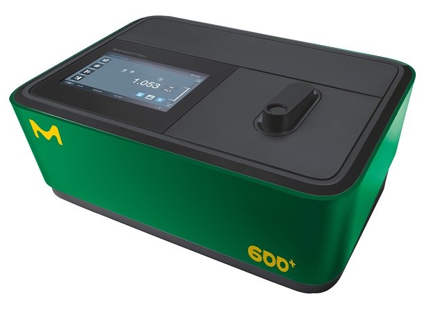 Spectroquant® Prove 600 plus, a green and black benchtop spectrophotometer with a sleek design. It features a touchscreen interface displaying measurement data and various control icons. The device has a cuvette slot on the right side of the screen and prominently displays the Merck logo and the model number "600" in yellow on the front.