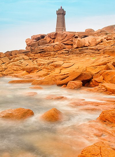 An artistic representation of a Molecular Beacon as a lighthouse, symbolizing its role in illuminating specific sequences within a vast genomic landscape.