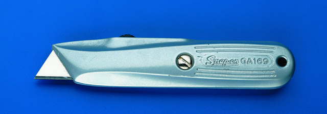 Utility knife safety lock secures blade in any of four positions